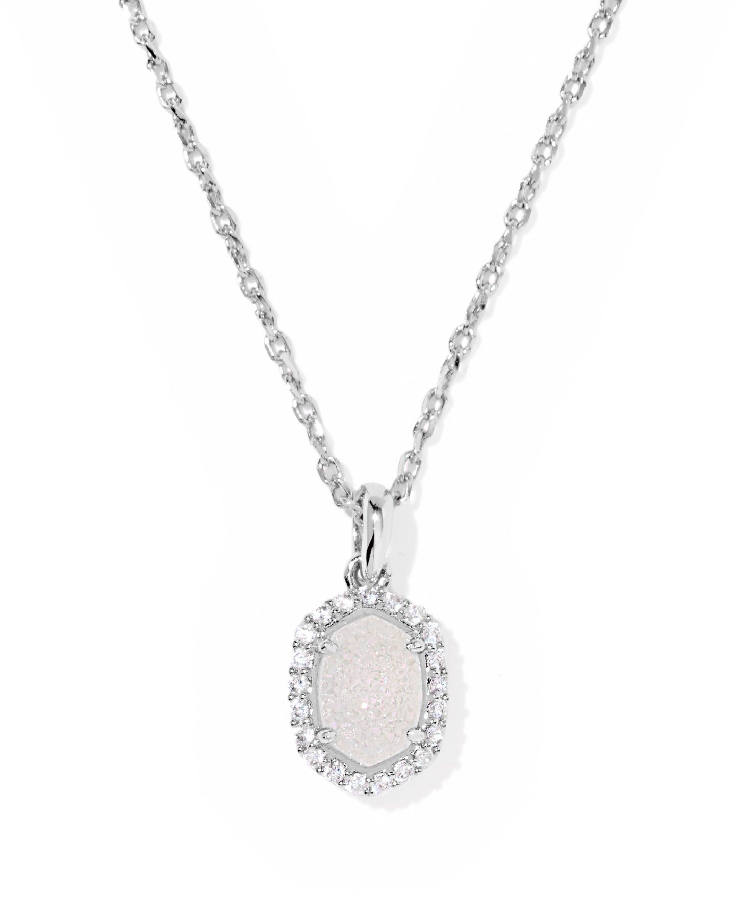 Add a touch of elegance to your jewelry collection with the Kendra Scott - Necklace - Daphne Silver Crystal Frame Short Pendant - Iridescent Drusy. This exquisite piece features a delicate crystal border surrounding a geometric pendant, designed to... - Findlay Rowe Designs